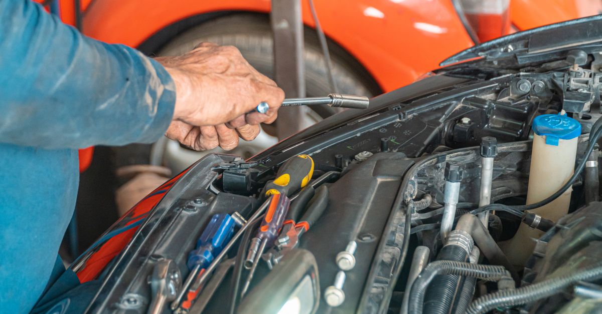 Auto Service Experts mechanic working on an engine in the repair bay